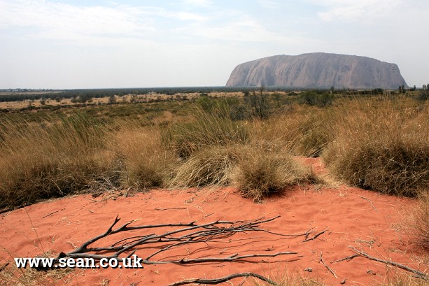 Photo of Uluru and red sand in Australia