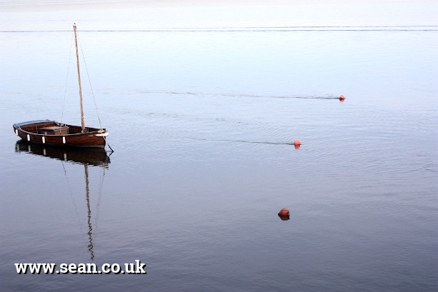 Photo of a boat out with the buoys in England