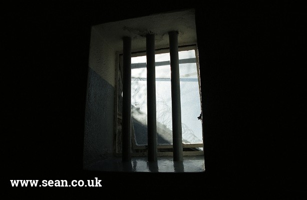 Photo of a barred window on Robben Island in South Africa