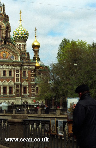 Photo of an artist painting The Church on Spilled Blood in St Petersburg
