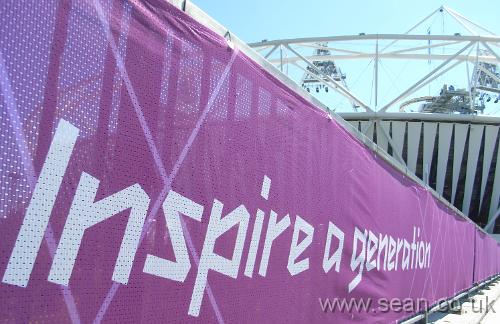 large banner saying 'inspire a generation' in front of stadium