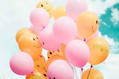 Balloons with happy and sad faces on them