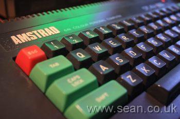 Amstrad CPC keyboard, showing bright green keys, and the Amstrad logo in silver