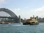 a ferry in front of Sydney Harbour Bridge