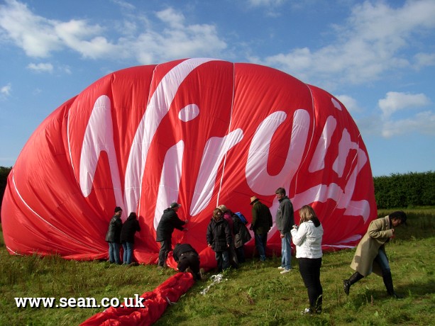 Photo of passengers collapsing the hot air balloon. in Hot Air Ballooning
