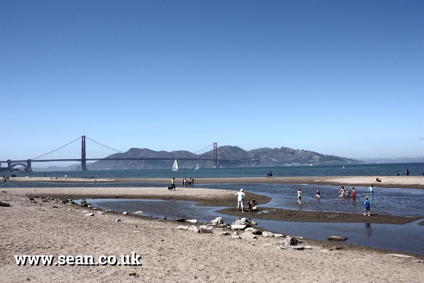 Photo of a beach and the Golden Gate Bridge in San Francisco, USA